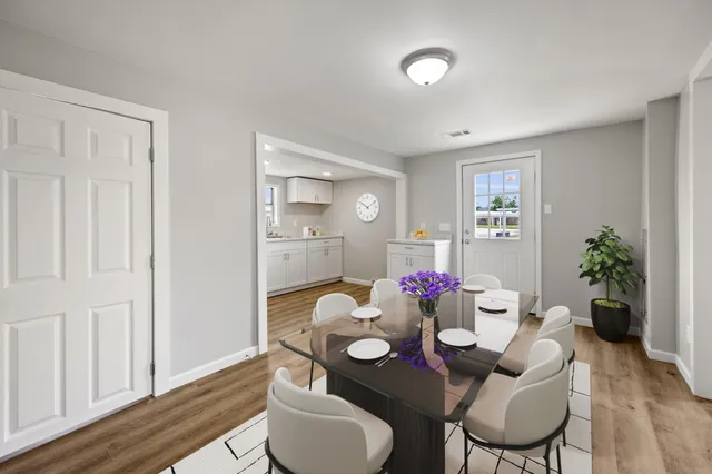 a dining room with furniture and wooden floor