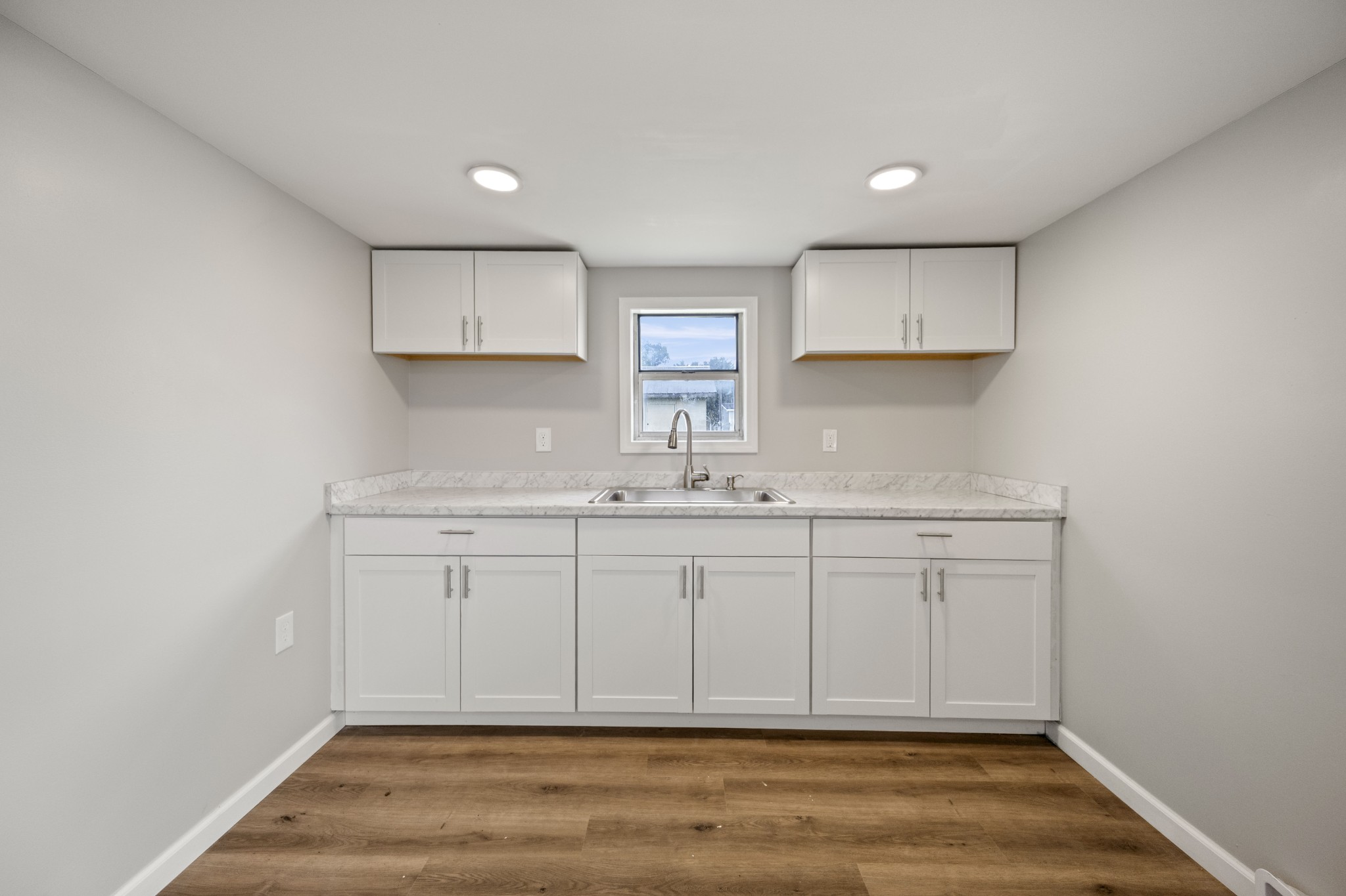 102 Hodges Street North Cowan, TN 37318 - Photo 14 of 23 a view of cabinets a wooden floor and a window