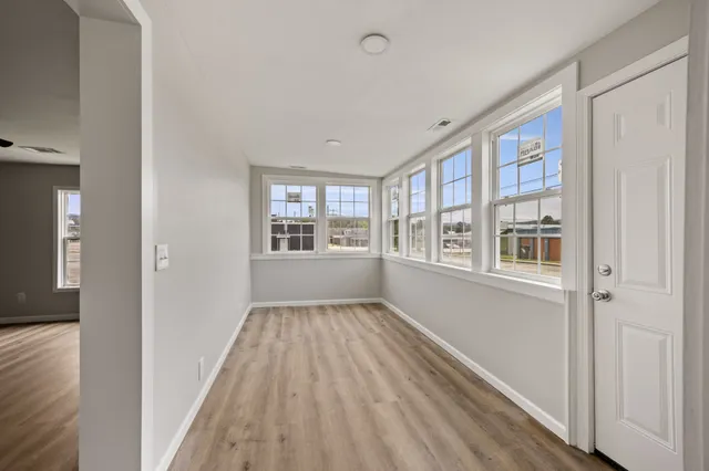 wooden floor in an empty room with a window
