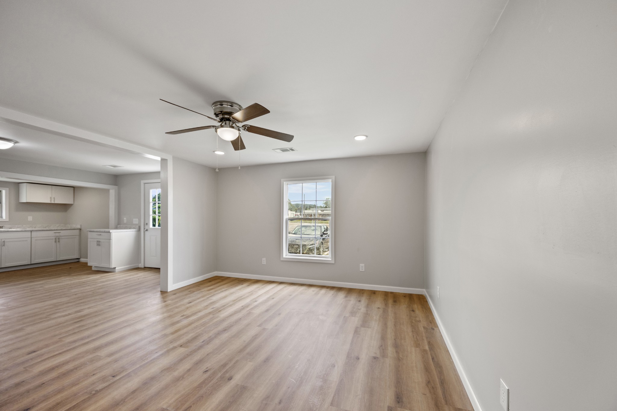102 Hodges Street North Cowan, TN 37318 - Photo 9 of 23 wooden floor in an empty room with a window