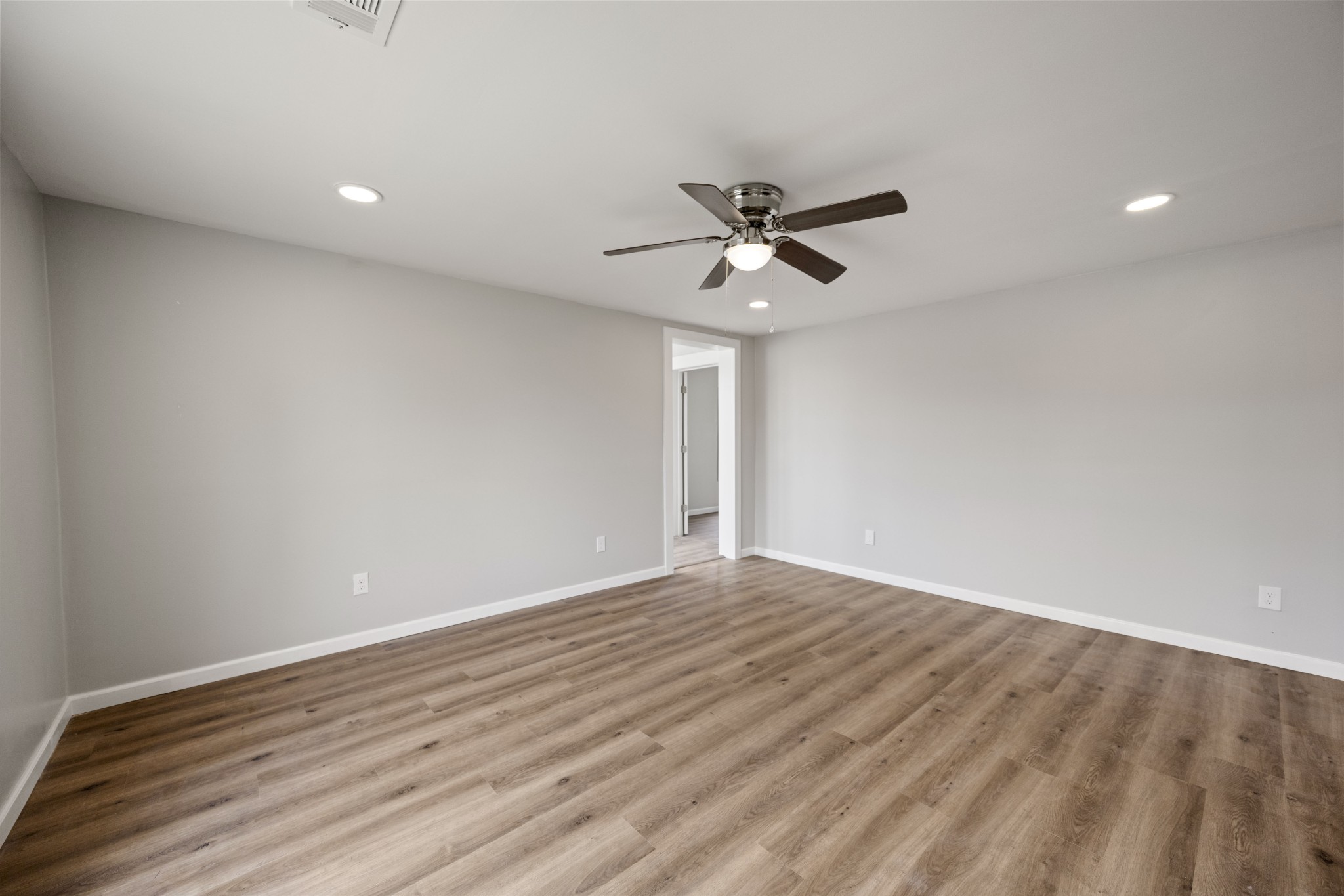 102 Hodges Street North Cowan, TN 37318 - Photo 10 of 23 a view of a big room with wooden floor and a ceiling fan