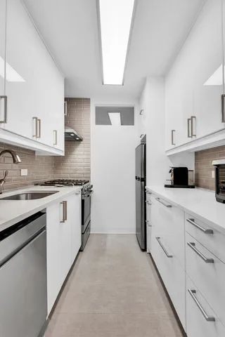 a view of a kitchen with a sink dishwasher and a refrigerator