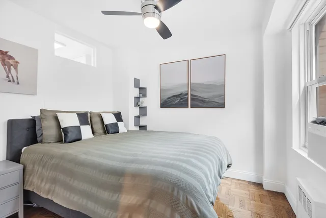 a kitchen with granite countertop white cabinets and refrigerator
