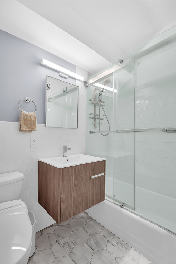 310 Lexington Avenue, Unit 9G Manhattan, NY 10016 - Photo 5 of 6 a bathroom with a sink toilet and shower
