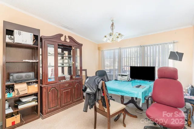 a view of a workspace with furniture and a kitchen