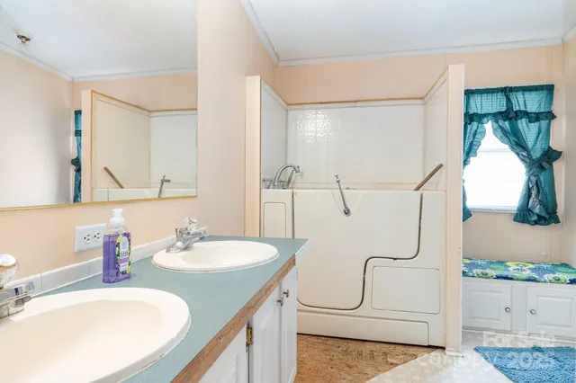 a bathroom with a sink mirror and vanity
