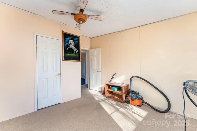 a view of a room with a window and a ceiling fan