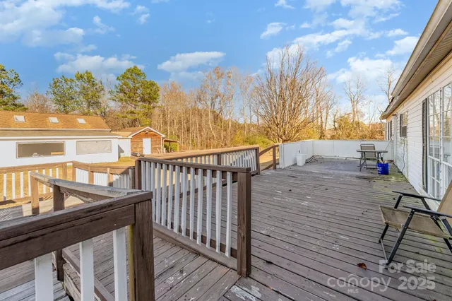 a view of a balcony with wooden floor and fence