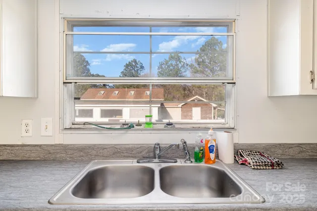 a kitchen with a sink and a window