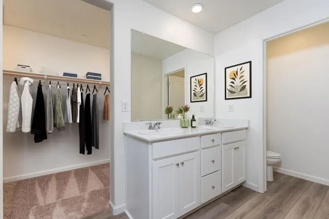 a bathroom with a double vanity sink and a mirror