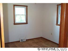 60 Osborne Farm Road Canton, NC 28716 - Photo 5 of 12 a view of an empty room with wooden floor and a window