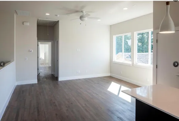 a kitchen with granite countertop a stove a sink and a microwave