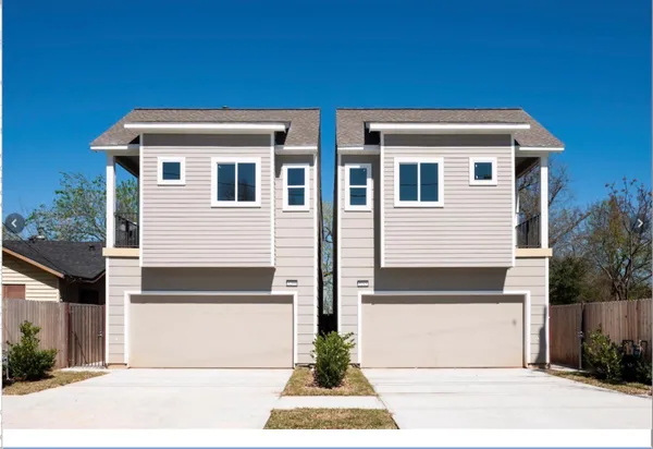 a view of a blue house with a small space