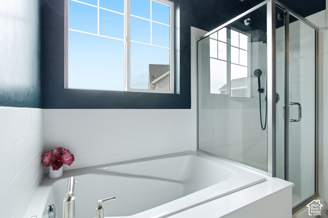 986 South Old Farm Road Heber City, UT 84032 - Photo 24 of 51 Built-in soaking tub with polished chrome fixtures, glass-enclosed shower with a rainfall showerhead, and a grid-pattern window