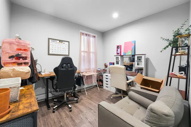 a work room with furniture and a wooden floor