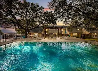 a house view with swimming pool and sitting space
