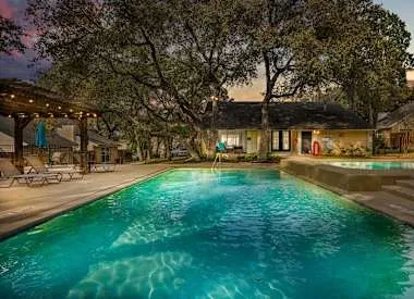 a view of yard with swimming pool and green space