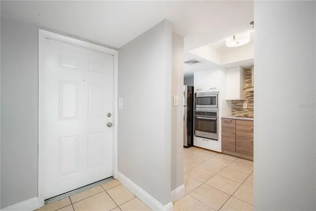a kitchen with stainless steel appliances granite countertop a refrigerator and a stove