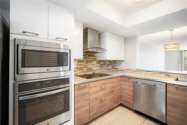 a kitchen with stainless steel appliances granite countertop a sink and cabinets