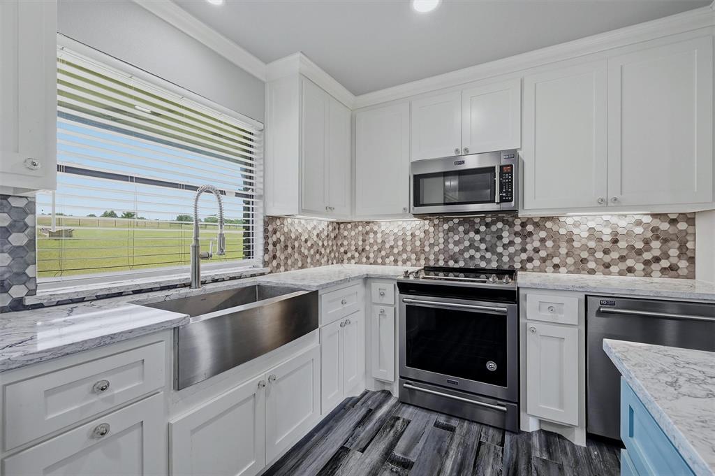 1861-1 Roland Road Whitesboro, TX 76273 - Photo 10 of 39 A large farmhouse sink, custom backsplash, and great view of the back pasture can all be found in the kitchen.