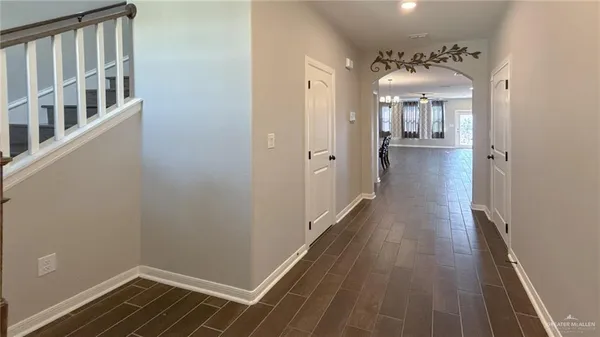 a view of a hallway with wooden floor and staircase