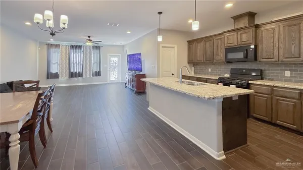 a kitchen with kitchen island a sink stainless steel appliances and cabinets