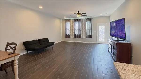 a living room with furniture and a wooden floor
