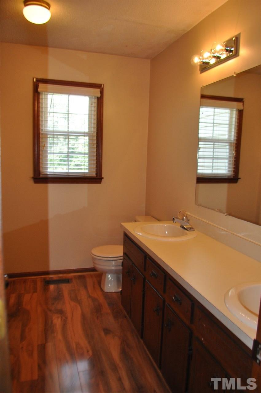 5616 Cleveland Road Clayton, NC 27520 - Photo 11 of 21 Large dual vanity sink, shower/tub combo and linen closet.