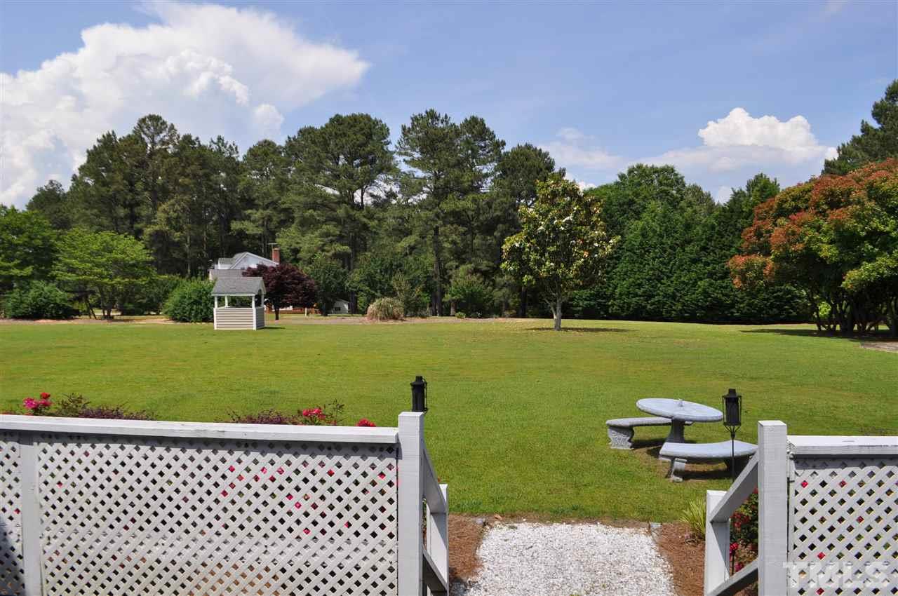 5616 Cleveland Road Clayton, NC 27520 - Photo 16 of 21 Dining area flows onto raised patio and overlooks beautiful backyard.
