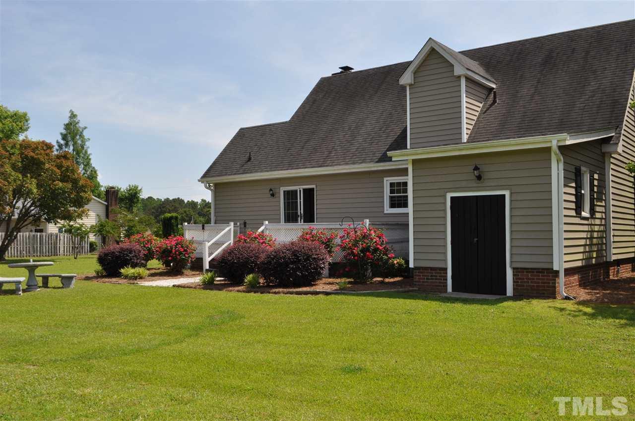 5616 Cleveland Road Clayton, NC 27520 - Photo 20 of 21 Large attached storage area and nice landscaping.