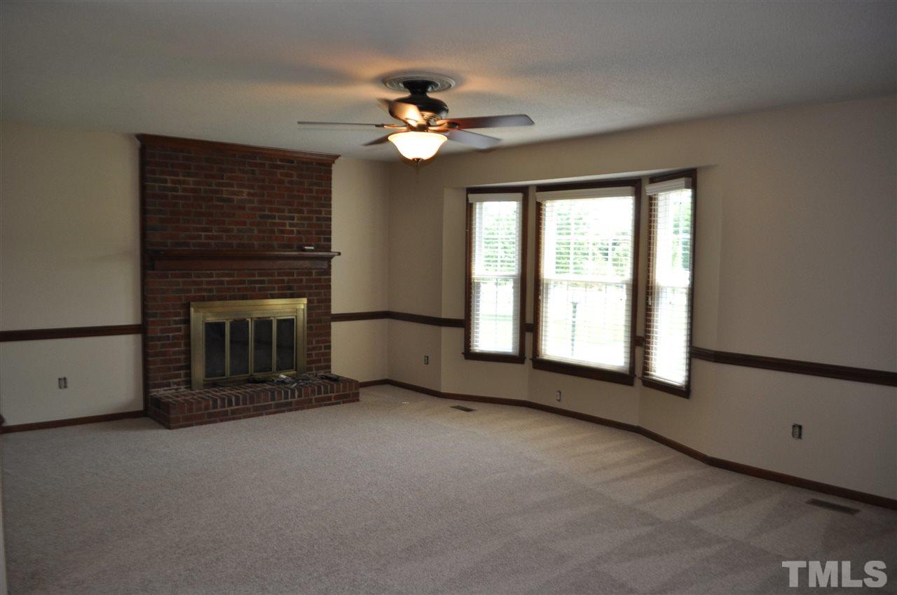 5616 Cleveland Road Clayton, NC 27520 - Photo 4 of 21 Family room with cozy brick fireplace. Brand new carpet and paint.