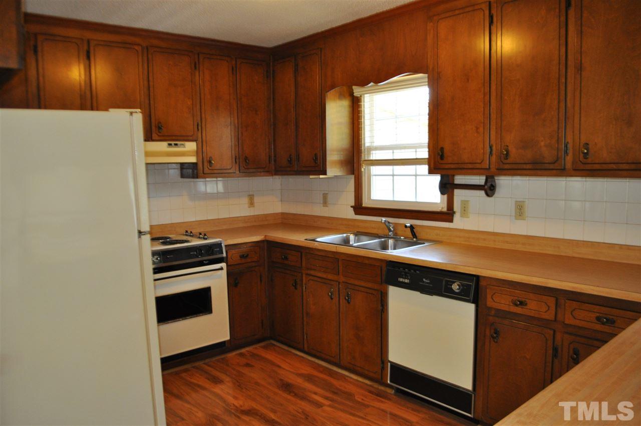 5616 Cleveland Road Clayton, NC 27520 - Photo 6 of 21 Plenty of cabinet space in this roomy kitchen. Refrigerator remains with home. Just bring the pots and pans!