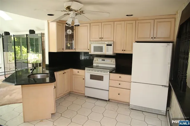 a kitchen with appliances cabinets and furniture