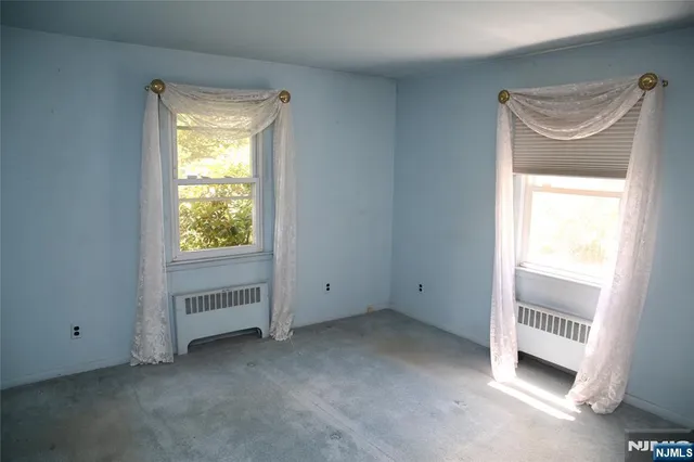 a view of an empty room and a window