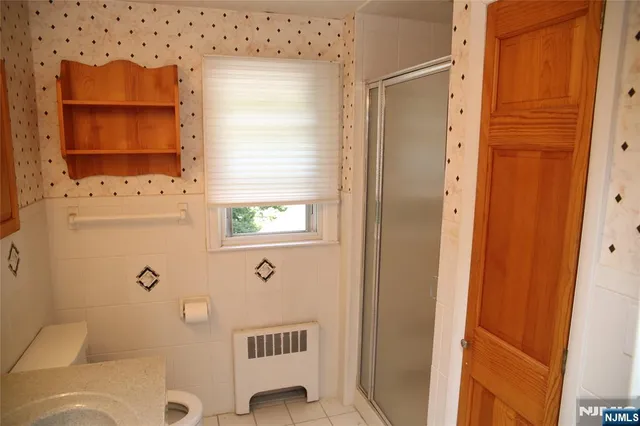 a bathroom with a toilet sink and shower