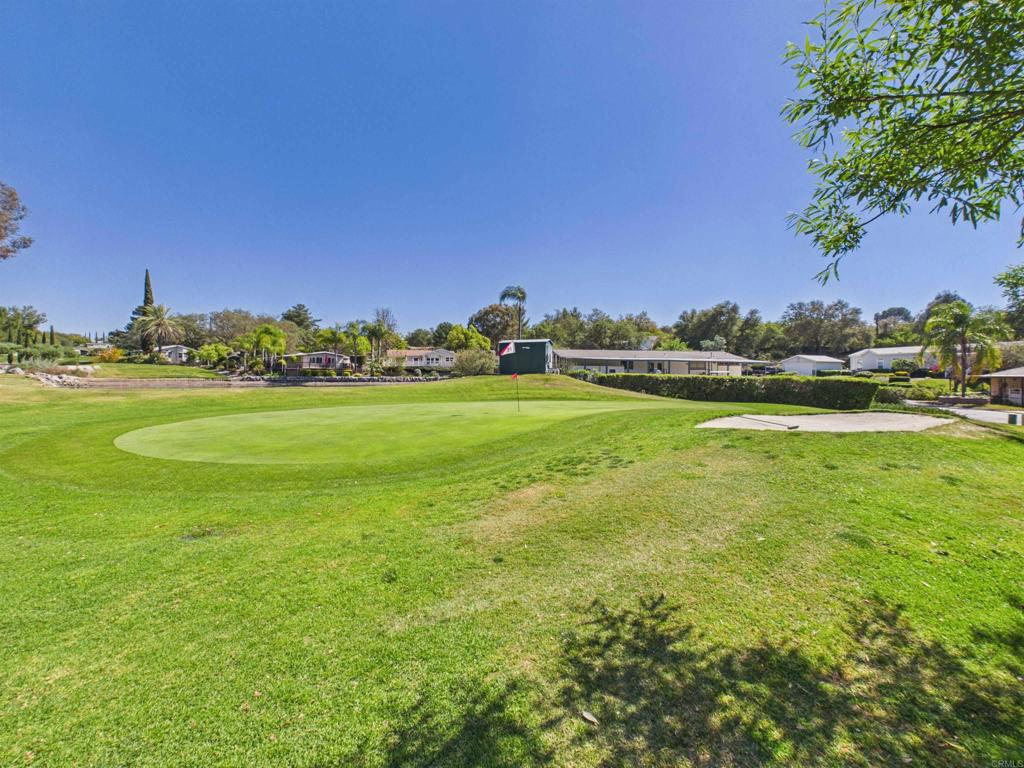 18218 Paradise Mountain Road, Unit 220 Valley Center, CA 92082 - Photo 23 of 48 a view of a big yard with a large trees