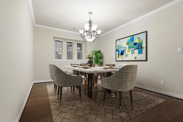a view of a dining room with furniture and a chandelier