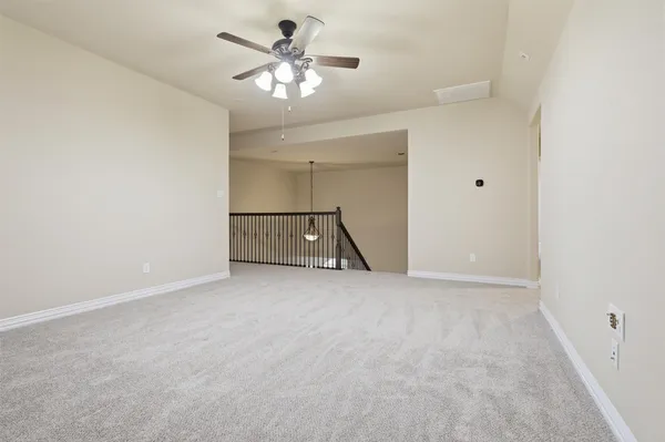 an empty room with a ceiling fan and a window