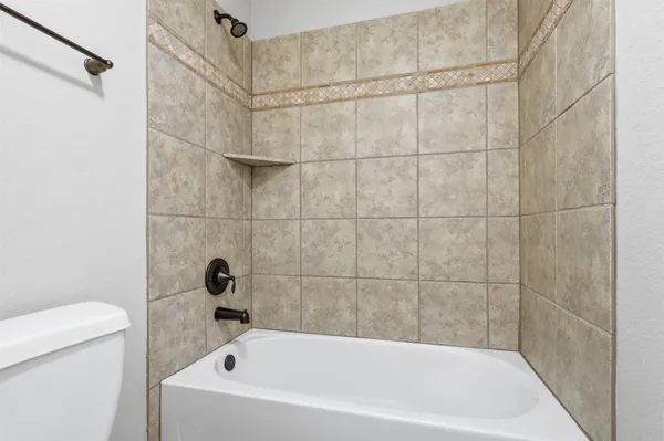 a bathroom with a bathtub and a toilet