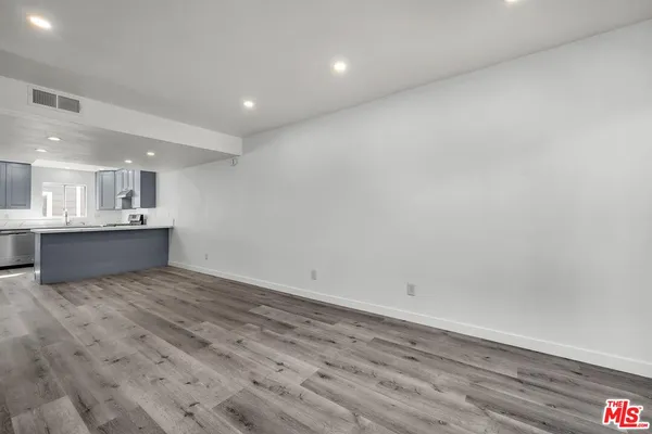 a view of kitchen and empty room