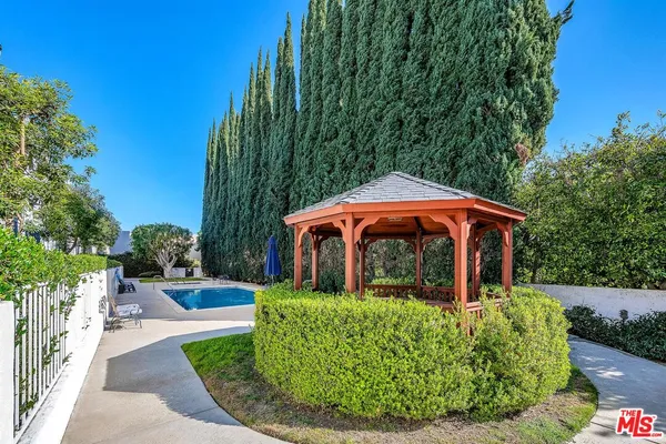 a view of a house with backyard sitting area and garden