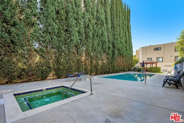 a view of a backyard with sitting area