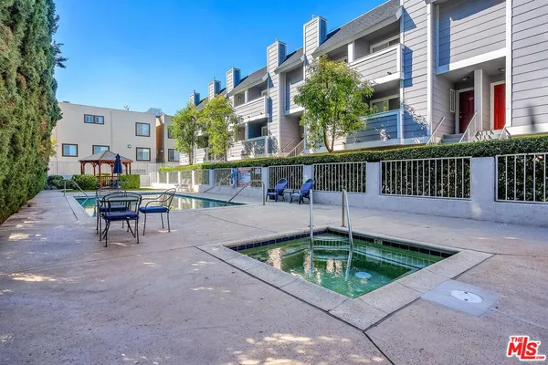 a swimming pool with outdoor seating and yard