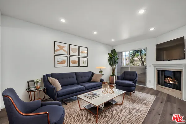 a living room with furniture a rug and a fireplace