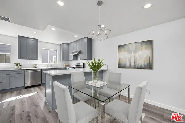 a kitchen with a table and chairs in it