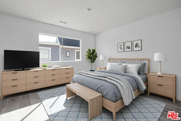 a bed room with a bed and a television