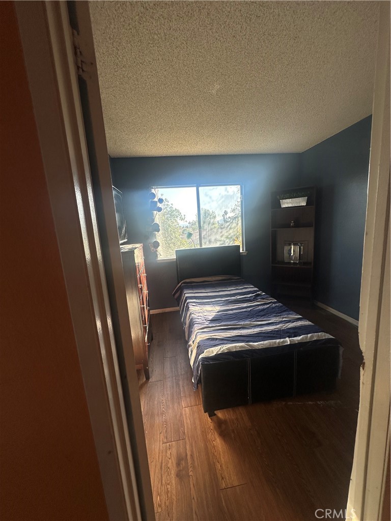 943 West Valencia Street Rialto, CA 92376 - Photo 11 of 18 a bedroom with a bed and a night stand