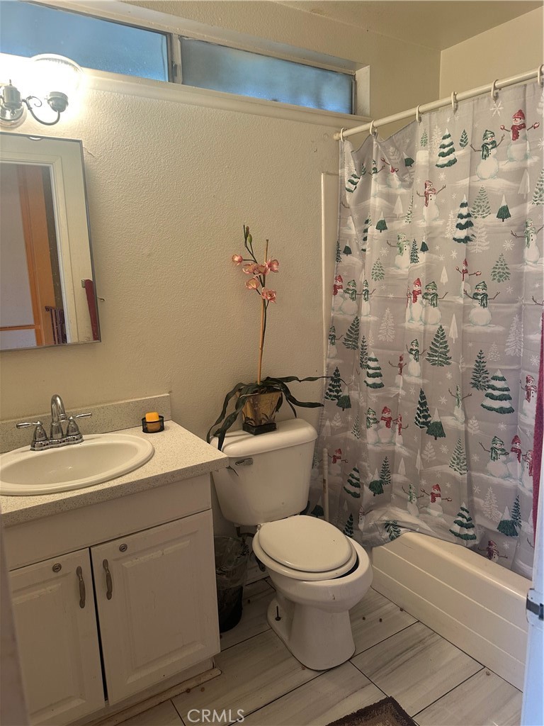 943 West Valencia Street Rialto, CA 92376 - Photo 12 of 18 a bathroom with a toilet sink and a shower