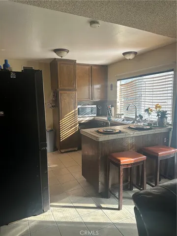 a kitchen with stainless steel appliances granite countertop a sink and a refrigerator