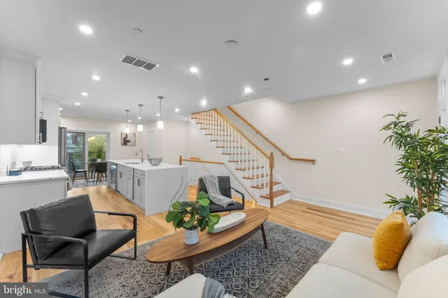 a living room with furniture and a potted plant